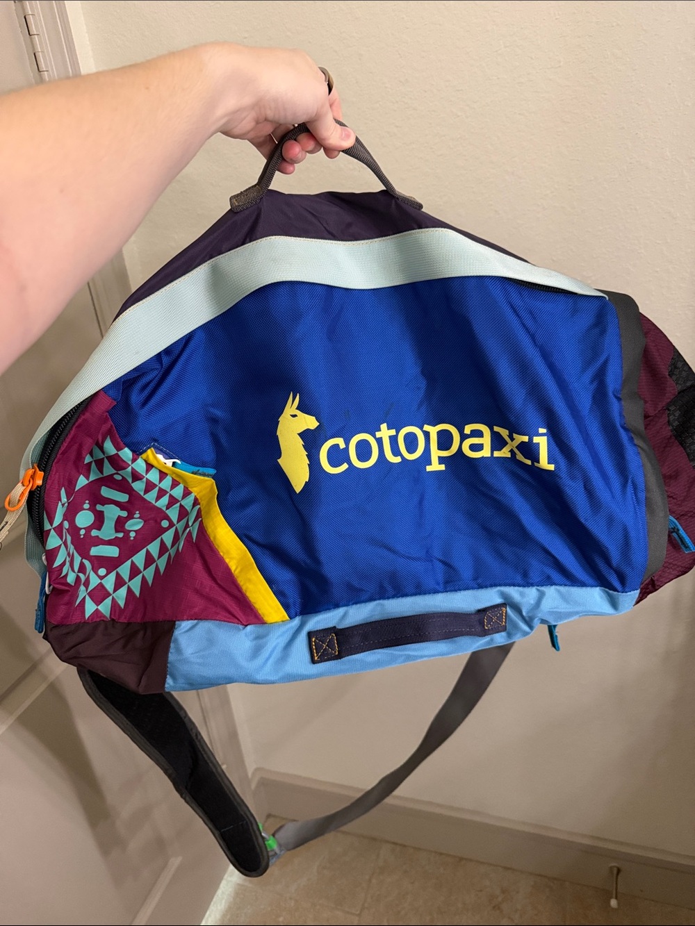 cotopaxi Blue & Teal Duffel with Yellow Logo and Maroon Accents